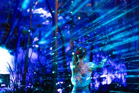 A child in front of blue light show
