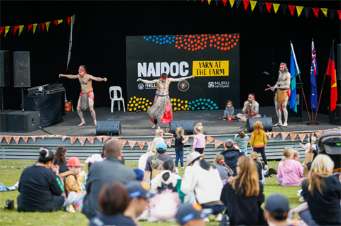 Yarn at the farm 2024 event. Indigenous dance taking place on the main stage with the crowd watching on from the foreground.